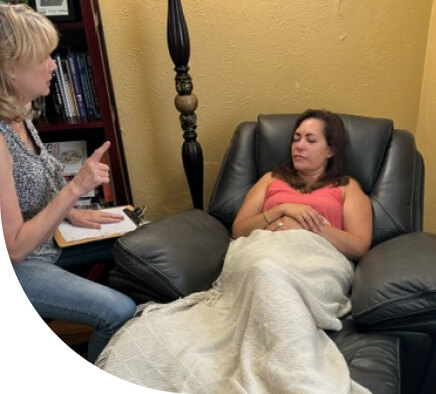 a patient on the couch with her caregiver
