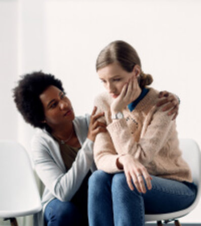 A woman comforts a sad woman.