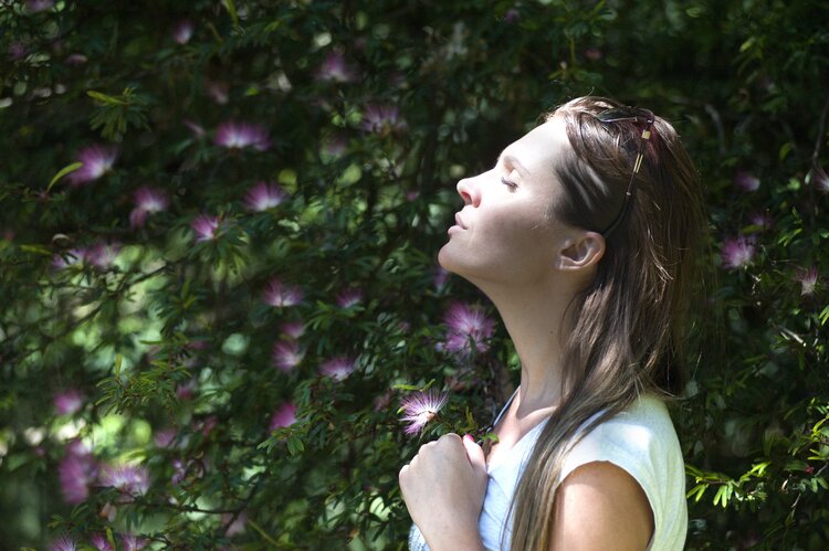 woman with flower behind